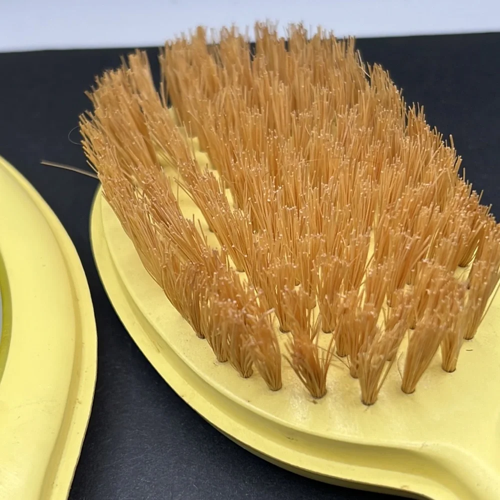 Vintage yellow celluloid vanity mirror, comb and brush set